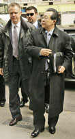 Two Diplomatic Security Special Agents, left and center, escort North Korean Vice Foreign Minister Kim Kye-Gwan to a meeting at the Korea Society in NYC, March 5, 2007. AP PHOTO.