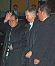 North Korean Vice Foreign minister Kim Kye-Gwan, escorted by two DS Special Agents ,right,, waves outside his NYC hotel March 2, 2007. AP PHOTO.