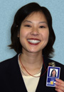 An employee proudly displays her State Department identification.
