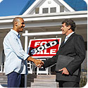 A man shaking hands with his realtor.  A 'sold' sign is between them.