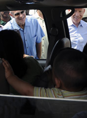 Secretary Michael Chertoff and Houston Mayor Bill White talk with people waiting in line at a  POD in Houston after the city was hit by Hurricane Ike, Sept. 17.