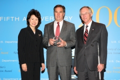 Secretary of Labor Elaine L. Chao (L) and Assistant Secretary of Labor for Disability Employment Policy W. Roy Grizzard (R) present a 2006 Secretary of Labor's New Freedom Initiative Award to V. Michael Ferdinandi, Senior Vice President, Human Resources, Corporate Communications and Community Relations, CVS/pharmacy. (DOL Photo/Shawn Moore)