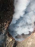 The surface of the lava lake in Halema`uma`u Crater was barely visible today through the thick fume.  A red tint in the upper right corner of the vent can be seen, but no clear views were captured due to the fume.