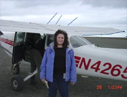 Tami standing in front of a small airplane