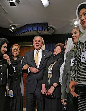 Meeting with Afghan women teachers at the signing ceremony for the Afghanistan Freedom Support Act of 2002 in the Dwight D. Eisenhower Executive Office Building, December 4.