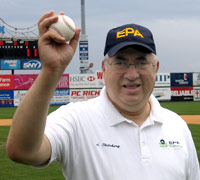 Alan Steinberg holds up a baseball