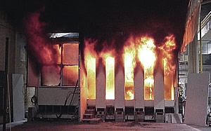 Photo showing NIST experimenting to replicate an office fire in the World Trade Center. Tests such as this helped validate computer models of the spread rate and intensity of the fires initiated by jet fuel and fed by the office furnishings and other combustibles.