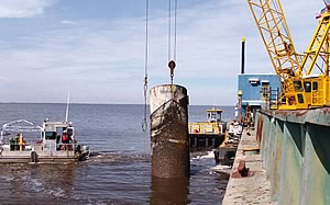 Photo showing marine debris being removed from Calcasieu Lake, LA using a crane, in January 2007.