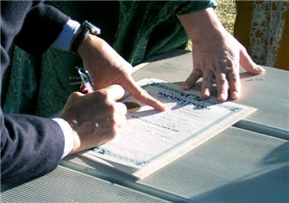 People signing a contract.