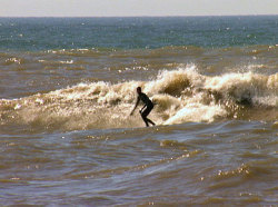 Grand Haven local Marc Hoeksema surfing Grand Haven; note the brown/blue line in the water