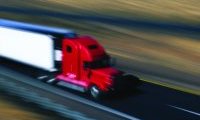 Cargo Truck driving on highway, blurred for speed