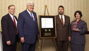 GPO officials present the Federal Depository Library of the Year Award to the Benton Harbor Public Library.  From left to right, Ric Davis, GPO’s Director of Library Services & Content Management; Bruce James, Public Printer of the United States; Fred Kirby, Benton Harbor Public Library Director; and Judy Russell, Superintendent of Documents.