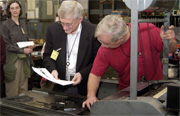 Pete Monaldi and Postal Museum curator Wilson Hulme check proofs