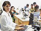 A science teacher in her classroom using a computer.