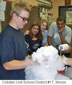 Picture of a student holding a beaker with dry ice (frozen carbon dioxide). 