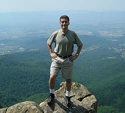 Photo of Ken Sandler standing on mountain