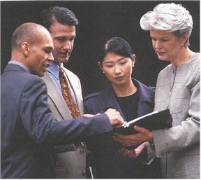 Picture of a Group of People Looking at a Book