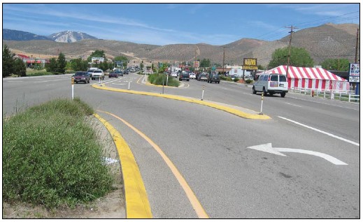 Photo of an unsignalized intersection where left turns are channelized for both approaching and oncoming traffic.