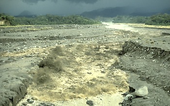 Lahar rushes down a confined river channel, Guatamala