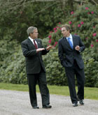 President George W. Bush and British Prime Minister Tony Blair walk through the grounds of Hillsborough Castle in Northern Ireland, Monday, April 7, 2003. White House Photo by Eric Draper