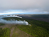 Steam and gas from a fissure (nearest) and a crack (farthest) that opened up some time last night (June 18 or 19). A small pad of new but cooling lava had issued from the fissure. Mauna Loa is in the far background and Mauna Ulu is in the near background.