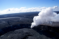 Aerial view of the gas and ash plume from Halema`uma`u with the gas plume from Pu`u `Ō `ō in the distance. The three hills on the horizon are, from right to left, Mauna Ulu (active 1969-1974), Kane Nui o Hamo (small eruption June 19, 2007), and Pu`u `Ō `ō.