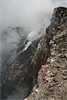 A momentary clearing of the fume in Pu`u `Ō `ō crater reveals a brief glimpse of the north crater wall.