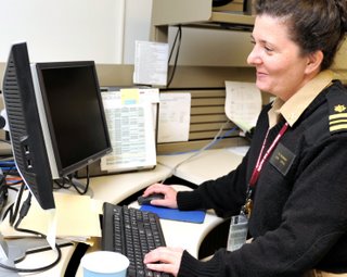 LCDR Leslie Hausman, a CDC epidemiologist assigned to the NBIC, at her workstation.