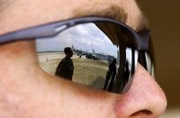 Close up photo of man in dark sunglasses.