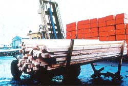 A powered industrial truck moves lumber.