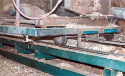 Log carriage with one rail sweep missing