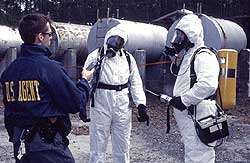 photo of cleanup technicians in protective moon suits