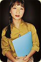 A woman holding a blue file folder.