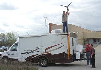 photo of staff mounting the windmill up on the side of the vehicle