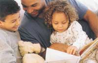 Image of father reading to son and daughter