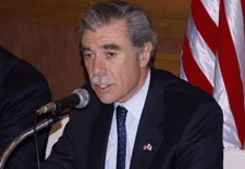 Secretary Gutierrez seated at microphone.