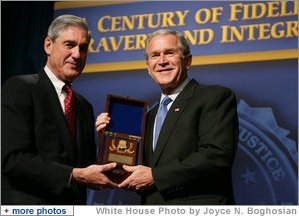 President George W. Bush is presented with an honorary FBI Special Agent credential by FBI Director Robert Mueller Thursday, Oct. 30, 2008, at the graduation ceremony for FBI special agents in Quantico, Va. White House photo by Joyce N. Boghosian