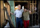 President George W. Bush shares a light moment with homeowner Ethel Williams during a visit to her hurricane damaged home in the 9th Ward of New Orleans, Louisiana, Thursday, April 27, 2006.  White House photo by Eric Draper