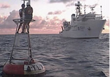 The NOAA research vessel, Ka'Imimoana, behind a moored TAO buoy. The TAO/TRITON array consists of 72 moored buoys in the Tropical Pacific Ocean used to collect oceanographic and meteorological data for monitoring, forecasting, and understanding of climate swings associated with El Niño and La Niña.