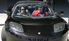 Secretary Rice prepares to take a test ride on the 2007 Tesla Roadster electric car along with Tesla sales manager Tom OLeary.  [© AP Photo]