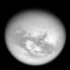 Bright mid-latitude clouds near the bottom of this view hint at the ongoing cycling of methane on Titan