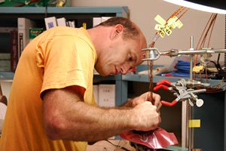 United Launch Alliance aerospace technician Kevin Wyckoff solders an electrical connector.