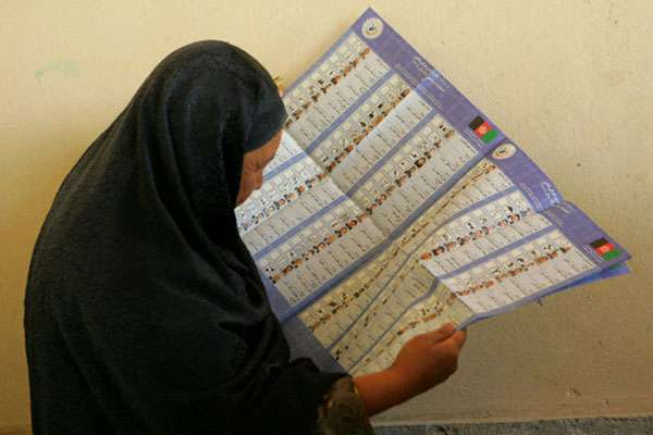 Afghan women looks over the ballot during the successful parliamentary and provincial elections held on September 18. The elections are a major step forward in Afghanistan's development as a democratic state governed by the rule of law. State Department photo