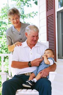 Grandparents enjoy some time on the porch with their grandson.