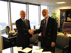 Acting Assistant Secretary David G. Dye and IMA-NA President Mark Ellis seal December 30, 2004 renewal of the Alliance agreement between MSHA and IMA-NA with a handshake.