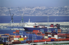 Photograph of freight containers in a port.