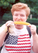 A woman eating corn on the cob.
