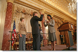 Mrs. Laura Bush observes the swearing-in ceremony of  Ambassador Mark Dybul as US Global AIDS Coordinator by U.S. Secretary of State Condoleezza Rice, Tuesday, Oct. 10, 2006, in the Benjamin Franklin Room at the U.S. Department of State in Washington, D.C.  White House photo by Shealah Craighead