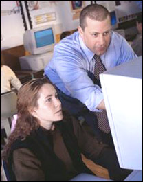 Woman and man looking at a computer