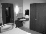 Photograph of patient room at St. Joseph Hospital. A clearly visible sink encouraged handwashing.